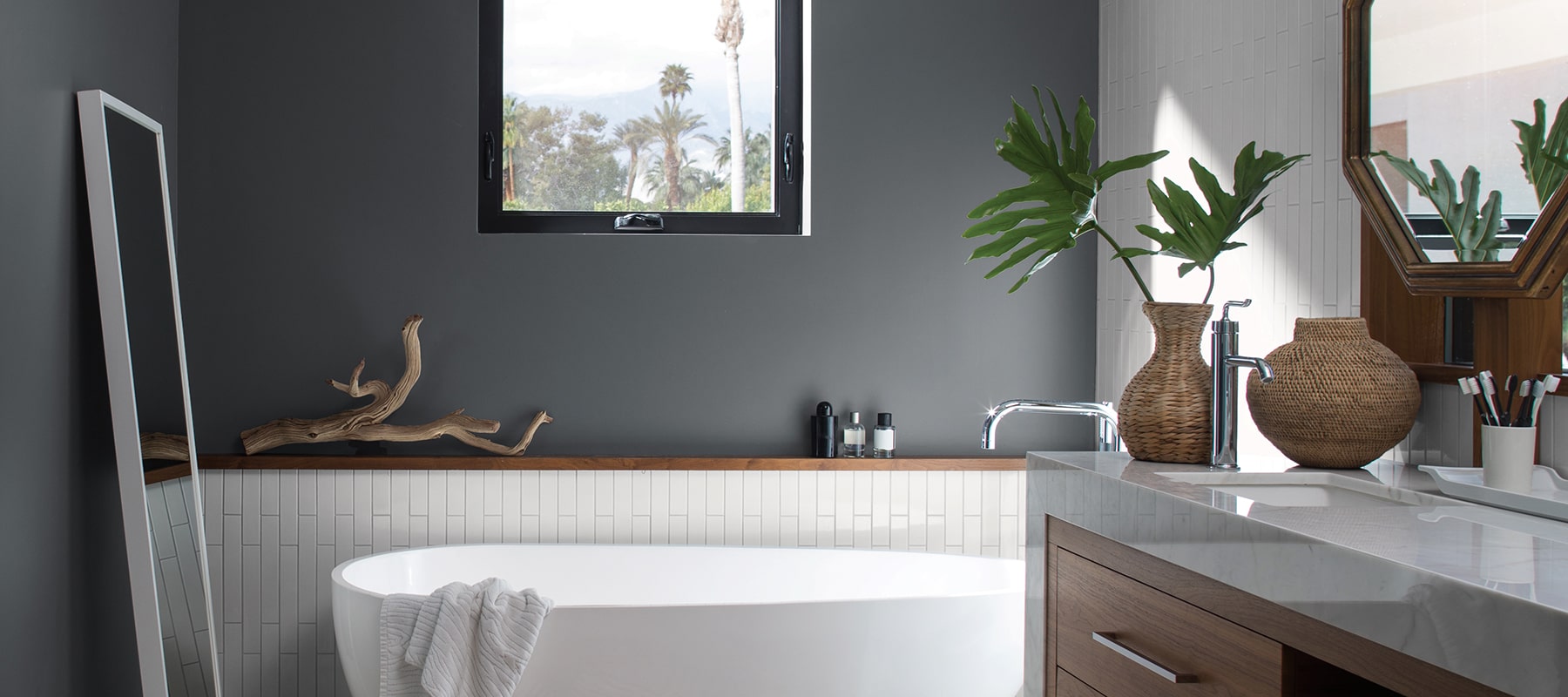 modern bathroom painted dark gray with white fixtures
